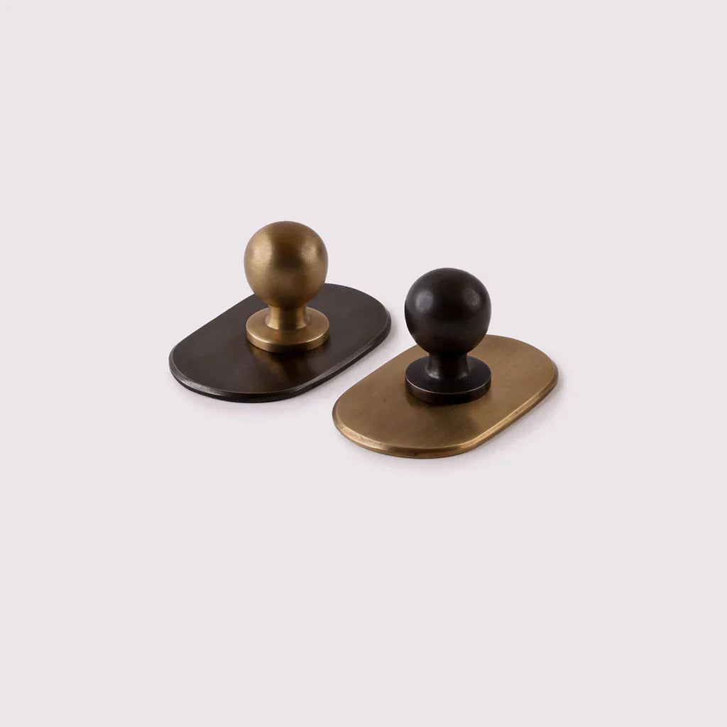 Curved Knob Backplate in antique bronze fitted to a door