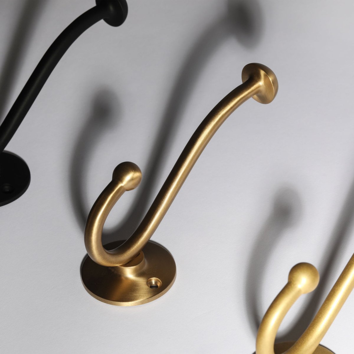 Eden Hook in burnished brass fitted to a wall