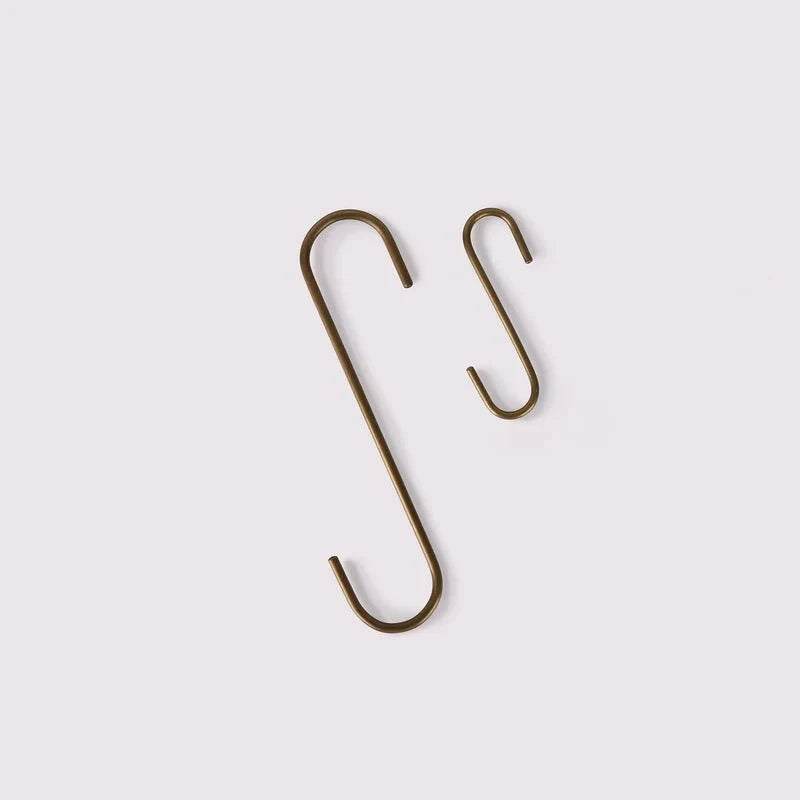 Brass S hooks hung on a rail